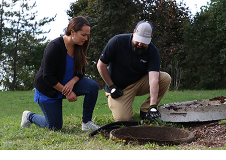 Premier Tech Water and Environment technician inspecting a homeowner's septic system in Pennsylvania.