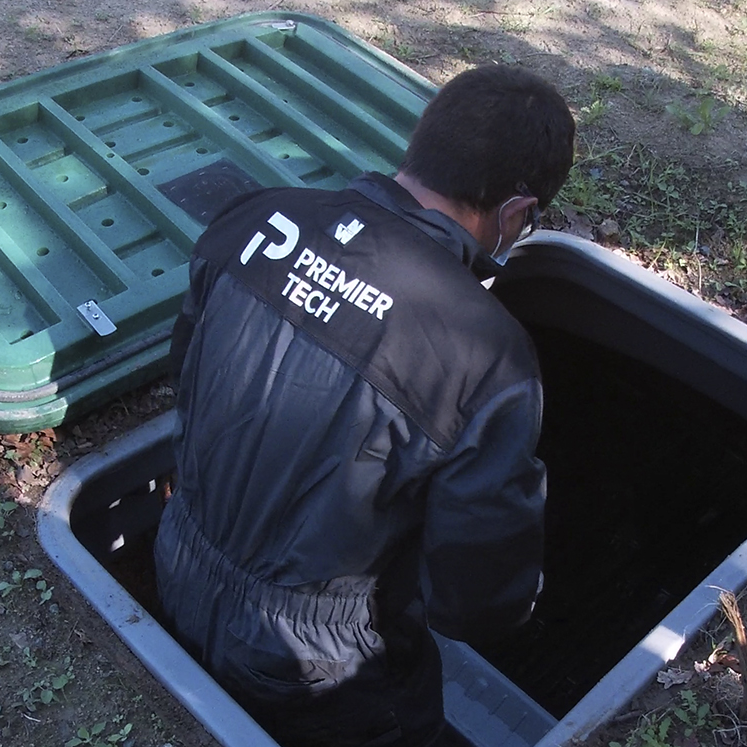 Premier Tech Water and Environment technician performing maintenance on a commercial sewage treatment plant in the UK.