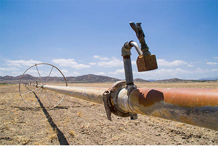 Water irrigation pipes on dry farmland in southern California.