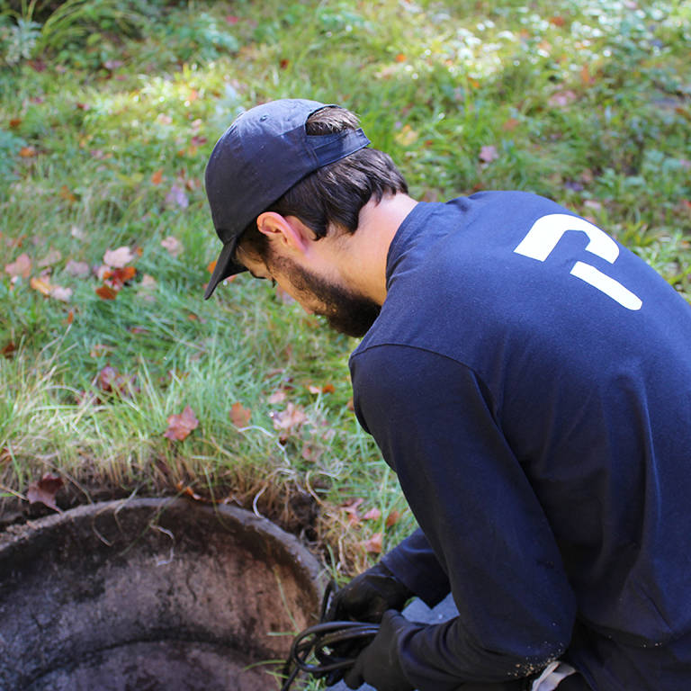 Premier Tech technician performing maintenance on a failing Bionest septic system.