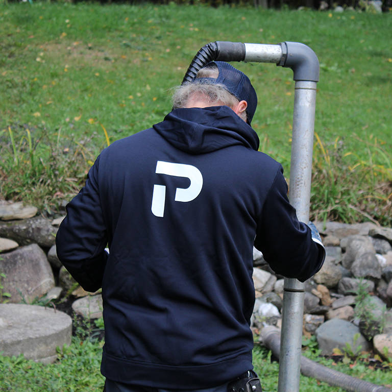 Technician racking sludge from a sewage treatment plant in the UK.