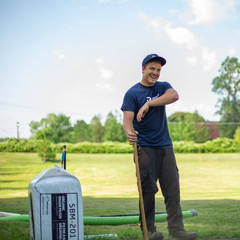Premier Tech Water and Environment field technician performing septic system maintenance in Iowa.